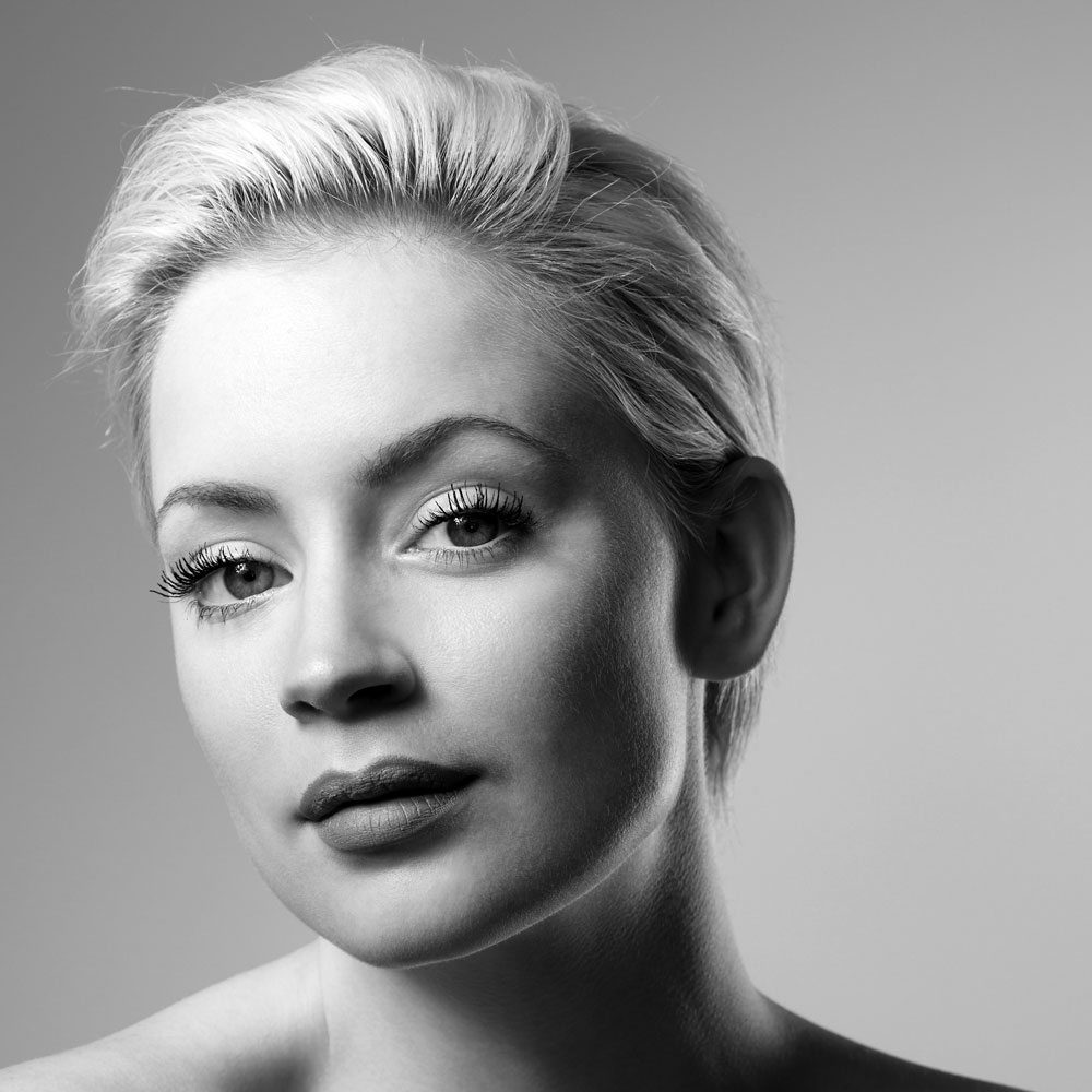 Black and white portrait of woman with short platinum blonde hair