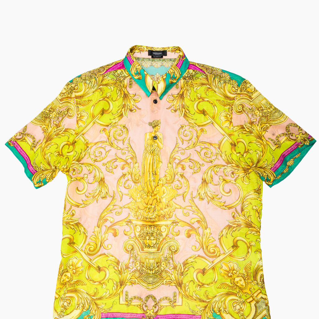 Versace short-sleeve shirt with gold baroque print and multicolor trim.